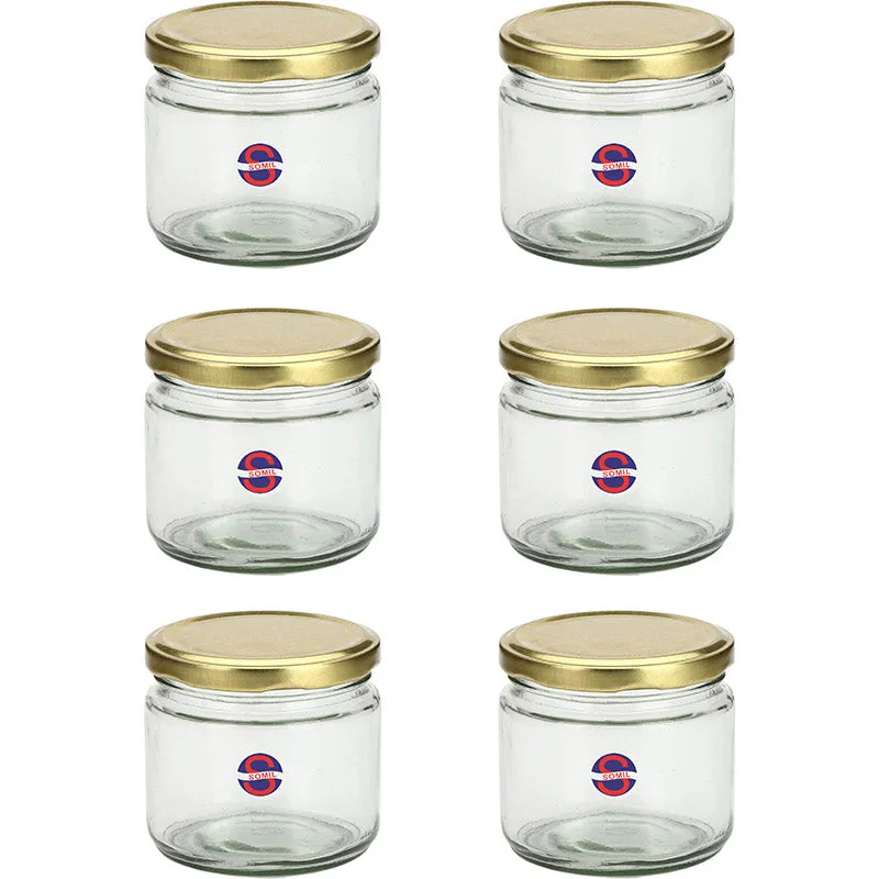 Six transparent glass storage jars with shiny gold lids arranged in two columns.