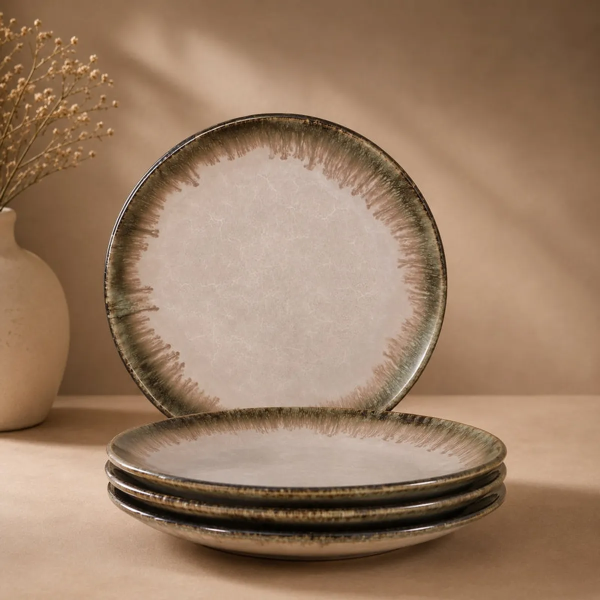 Stack of glossy pink ceramic plates with one plate standing behind