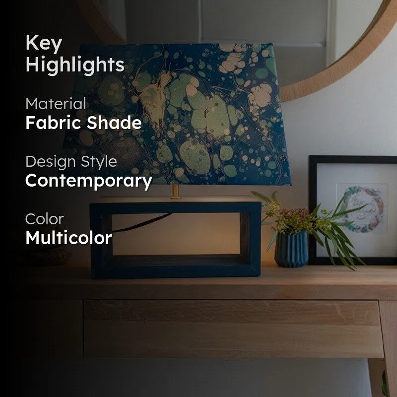 Blue marbled table lamp with key highlights overlay on a console table