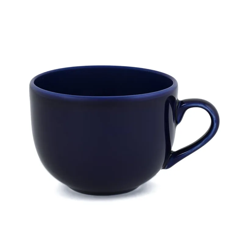 Close-up of a glossy blue cup with a curved handle