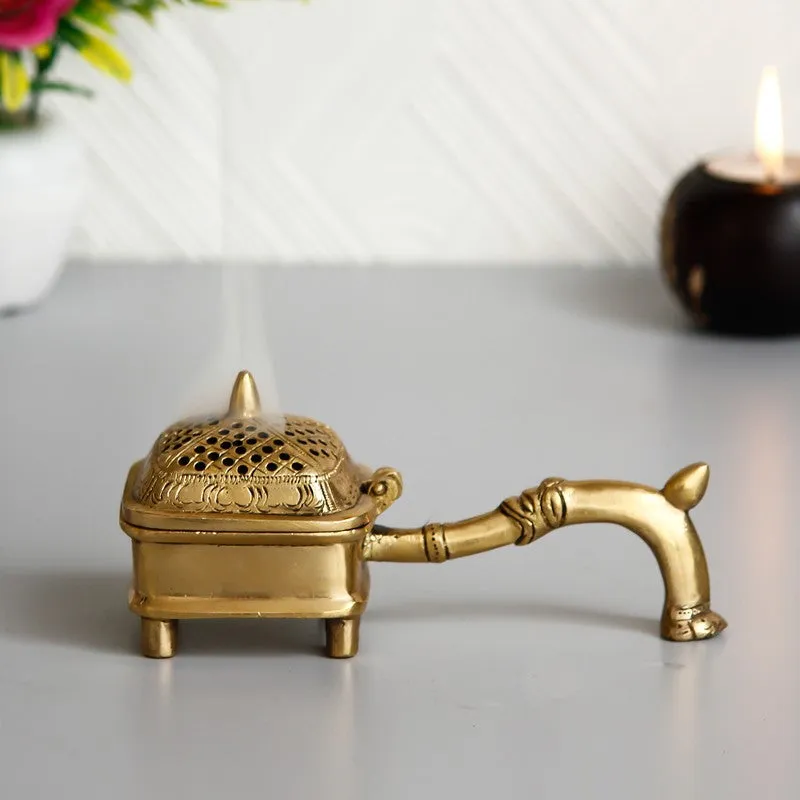 Side view of a gold brass incense holder with dome lid