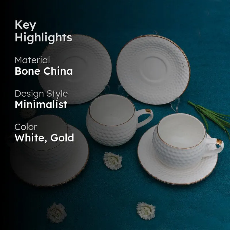 White and gold textured cup and saucer set shown in a styled arrangement