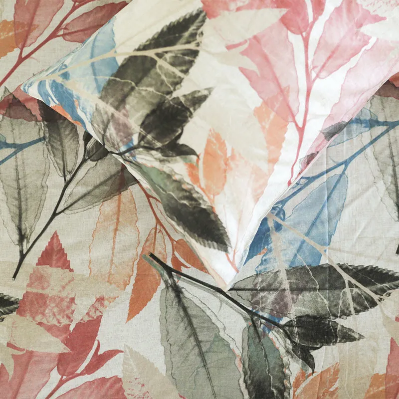 Close-up view of the duvet cover showing layered pink, blue and grey leaf motifs
