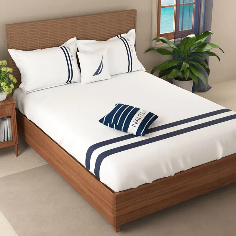 Angled view of white and navy striped cotton bedsheet on a double bed