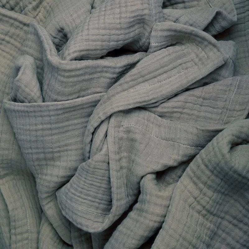 Close-up of the grey textured cotton fabric in soft gathered folds