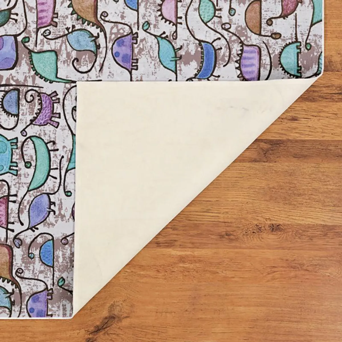 Back side corner of the carpet folded over on wooden floor