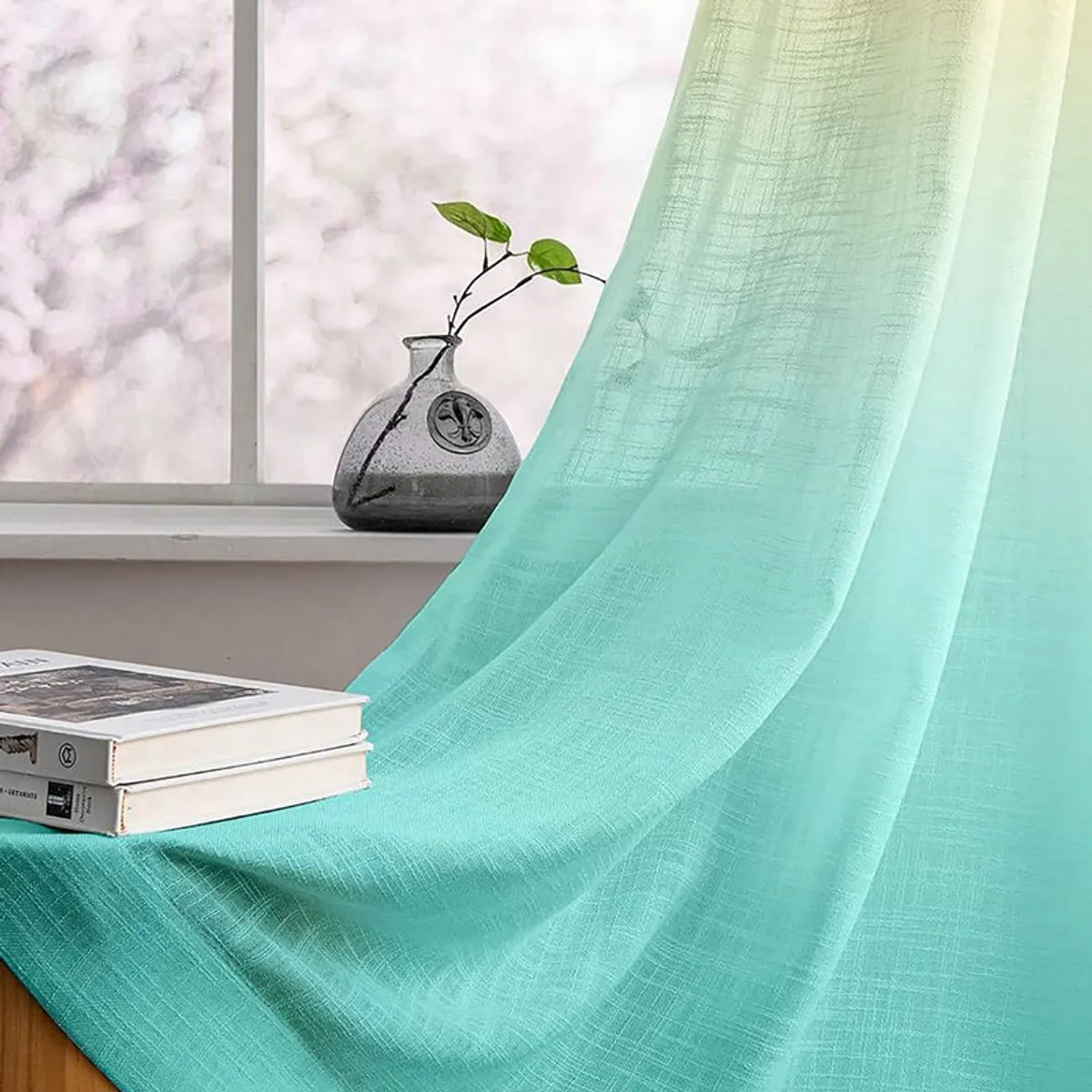 Close view of turquoise sheer curtain fabric beside a window
