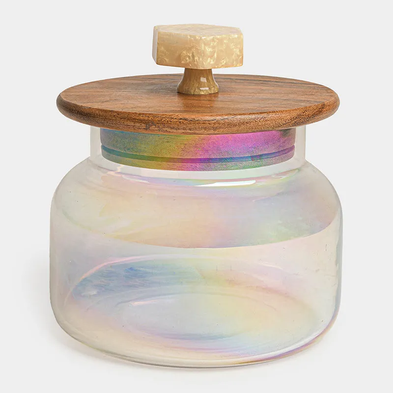 Close-up of a transparent iridescent glass jar with a brown wood lid and knob