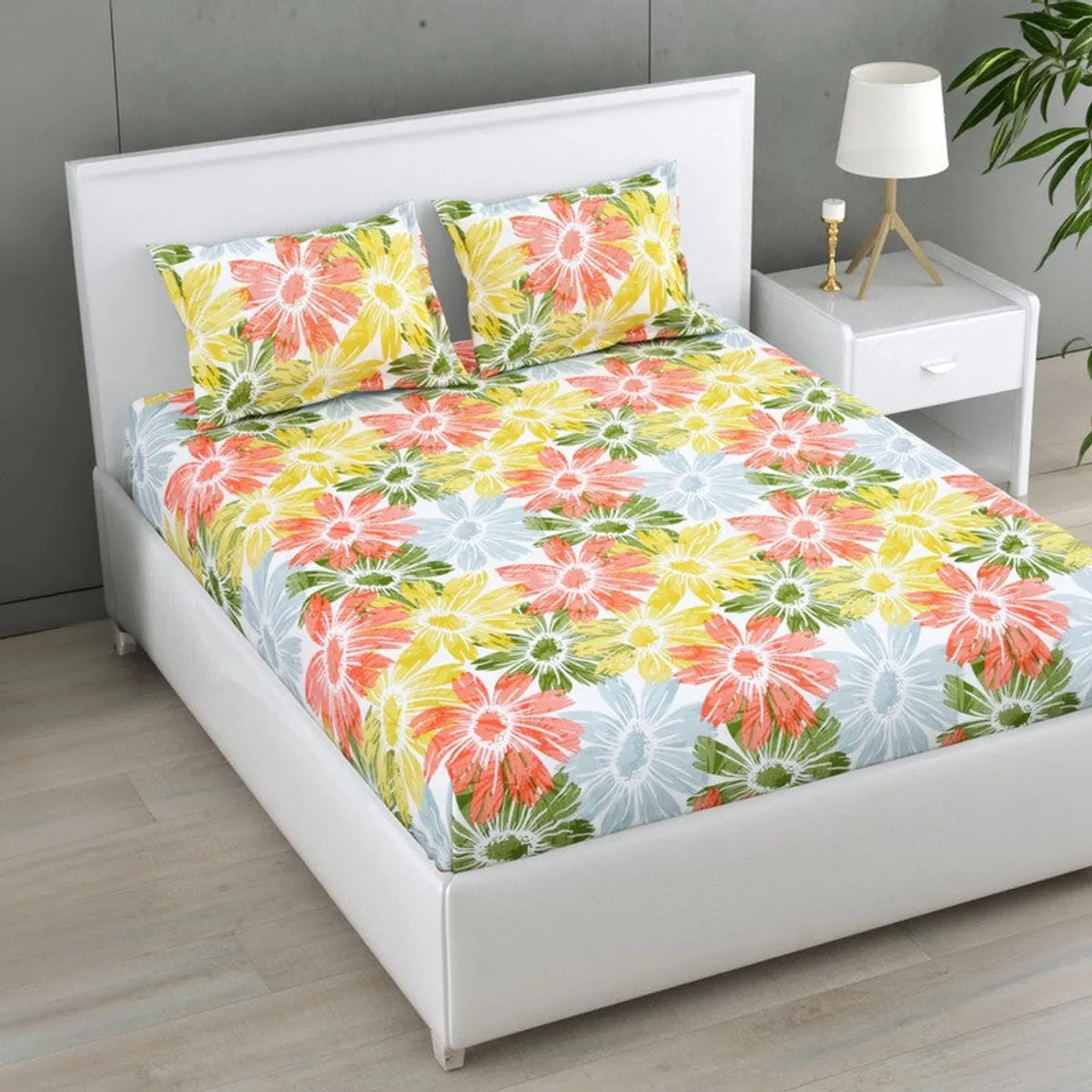 Angled view of colourful floral printed cotton bedsheet on a bed