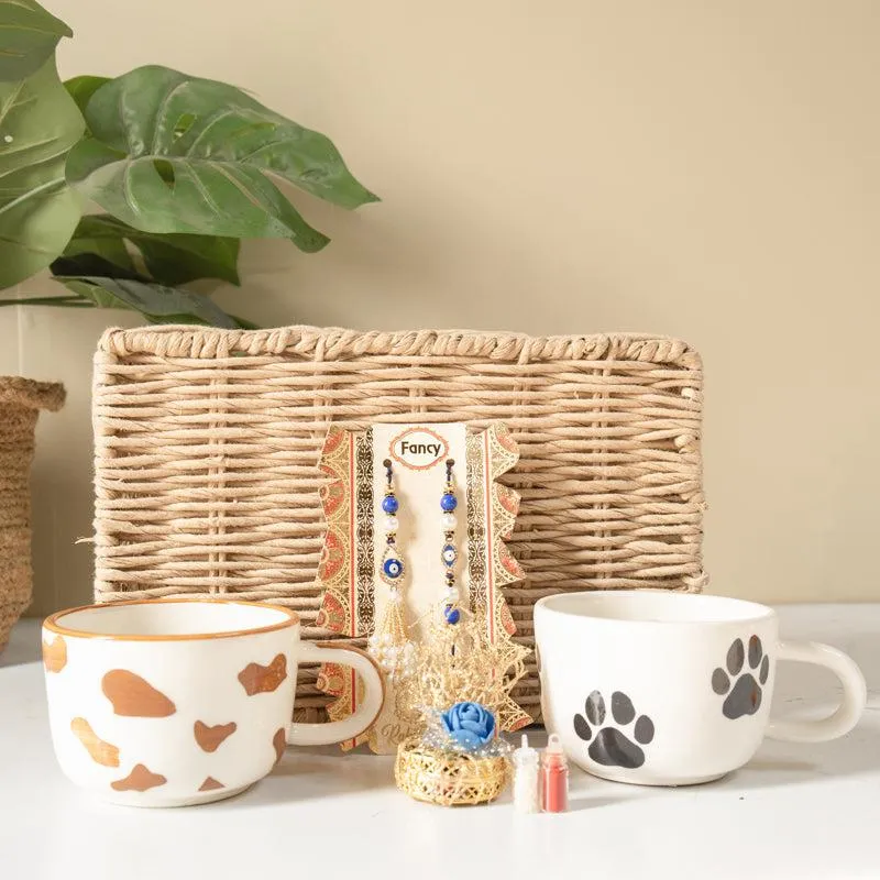 Pet lover Rakhi hamper with paw-print mug, patterned mug and woven basket