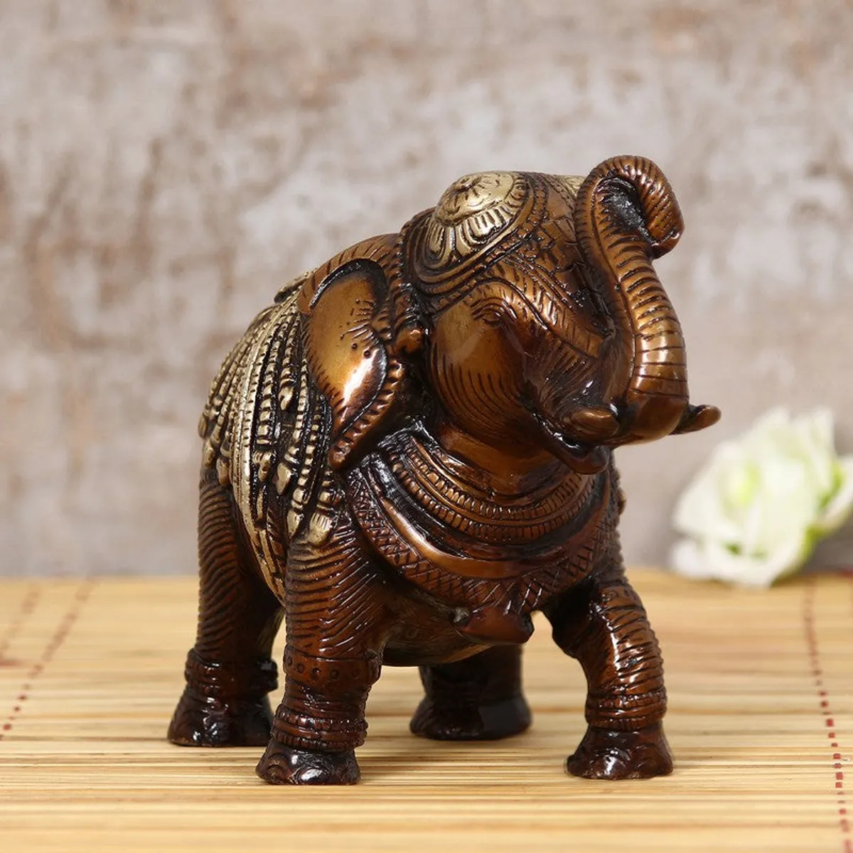 Front view of brown and gold elephant showpiece with ornate detailing