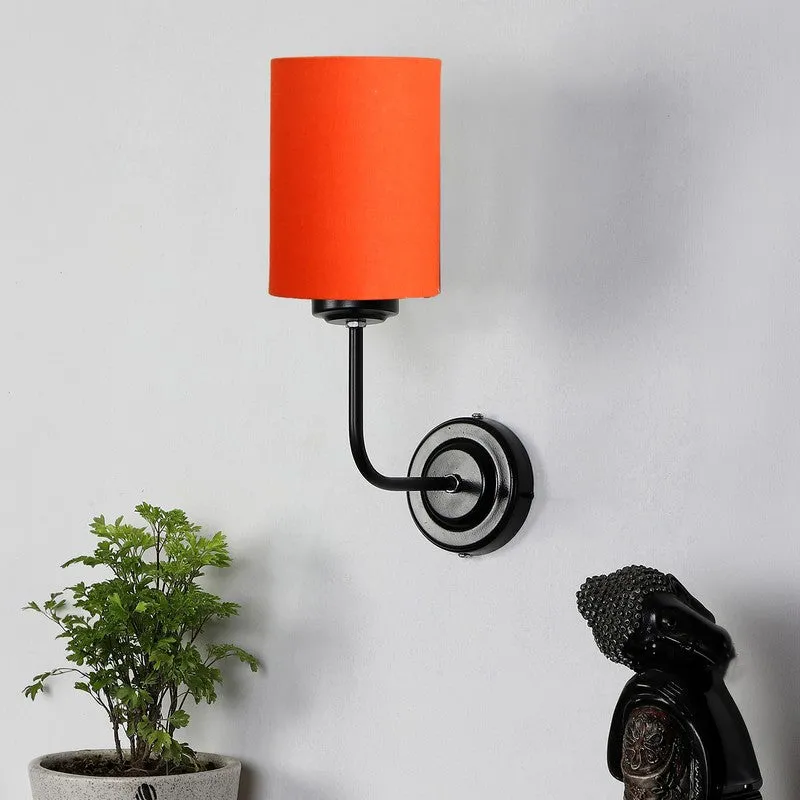 Orange cotton wall lamp with black iron base mounted on a white wall