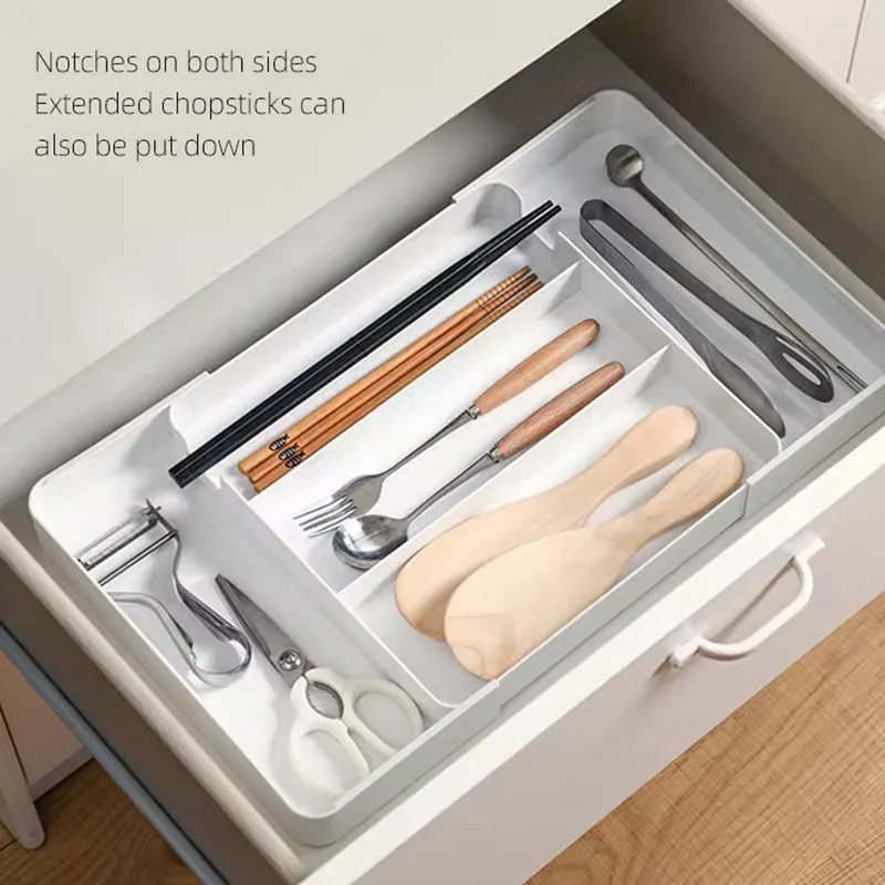 White cutlery tray in a drawer holding chopsticks, utensils and kitchen tools