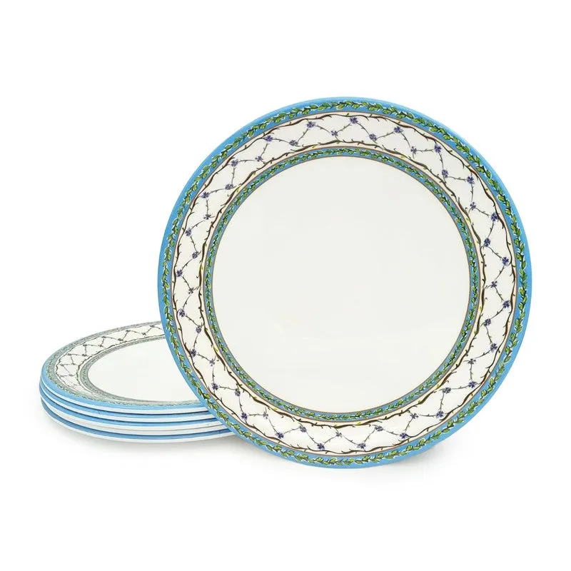 Blue and white patterned dinner plate displayed beside a stacked set