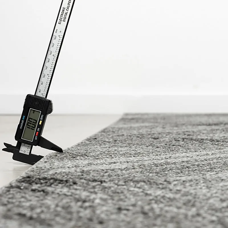 Side view of the grey carpet showing its low-profile edge
