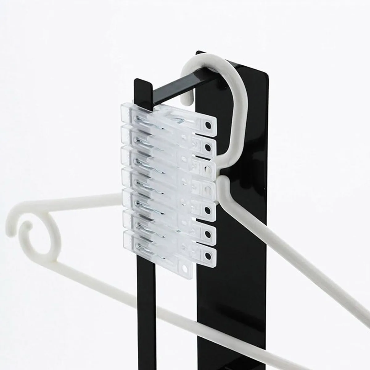 Close-up of black magnetic organiser holding clips and a hanger