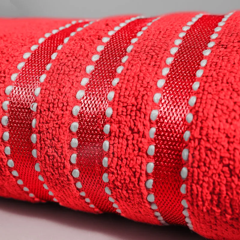 Close-up of red towel texture with shiny striped bands