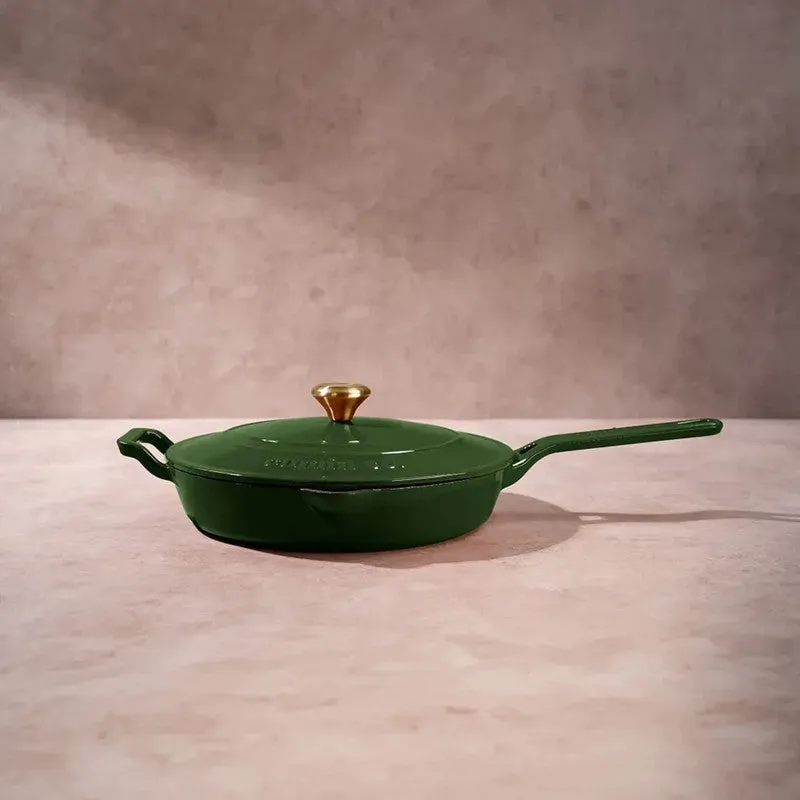 Green lidded frying pan shown in profile on a neutral surface