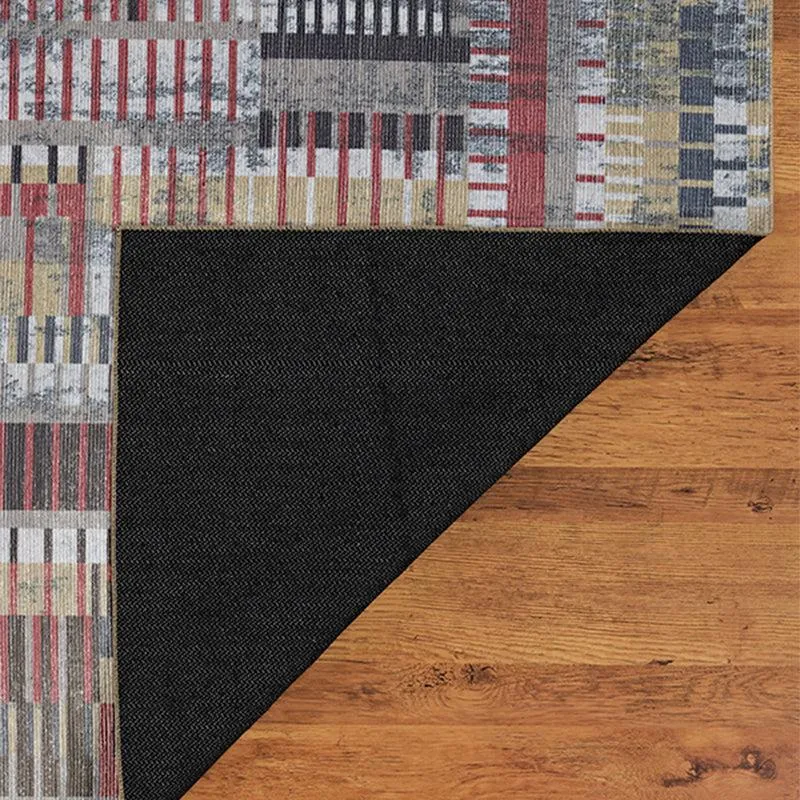 Corner of the carpet lifted to show the black underside