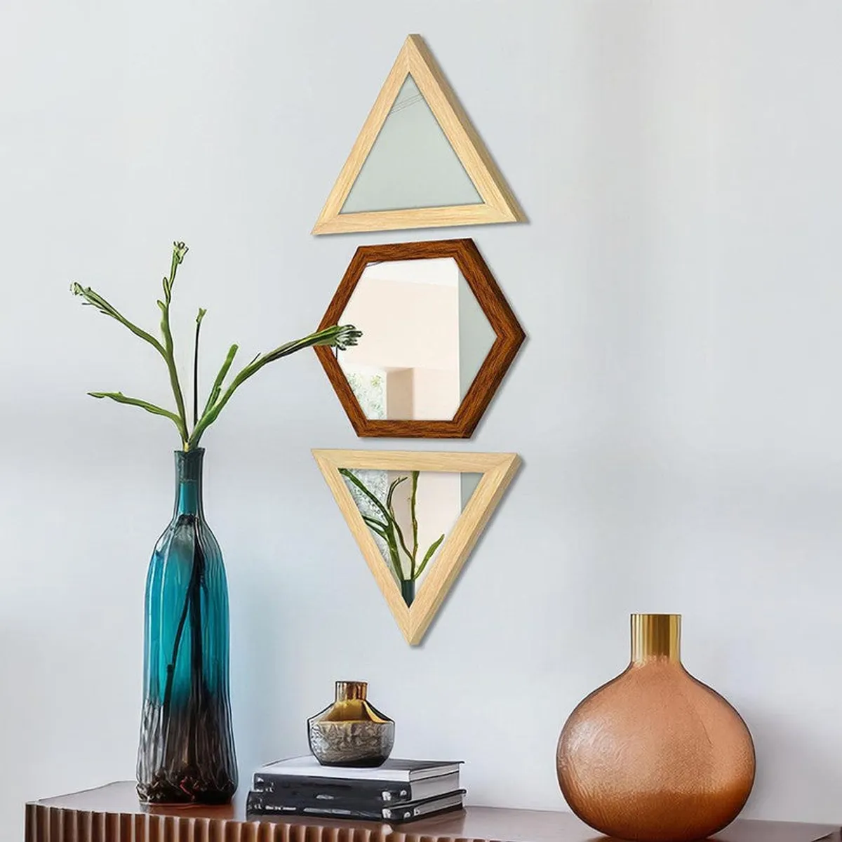 Set of three geometric wall mirrors in beige and brown above a console table