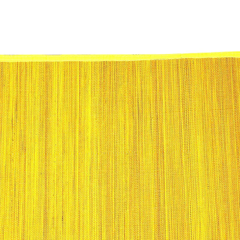 Close-up of the yellow textured surface and edging of a bamboo table mat
