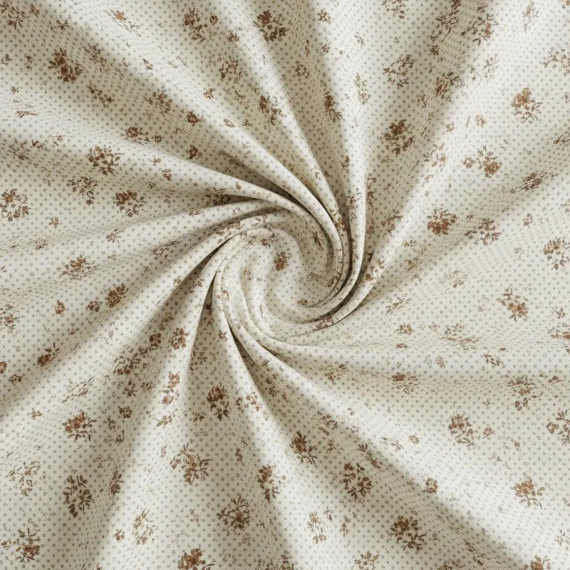Close-up of off-white fabric with small brown floral print