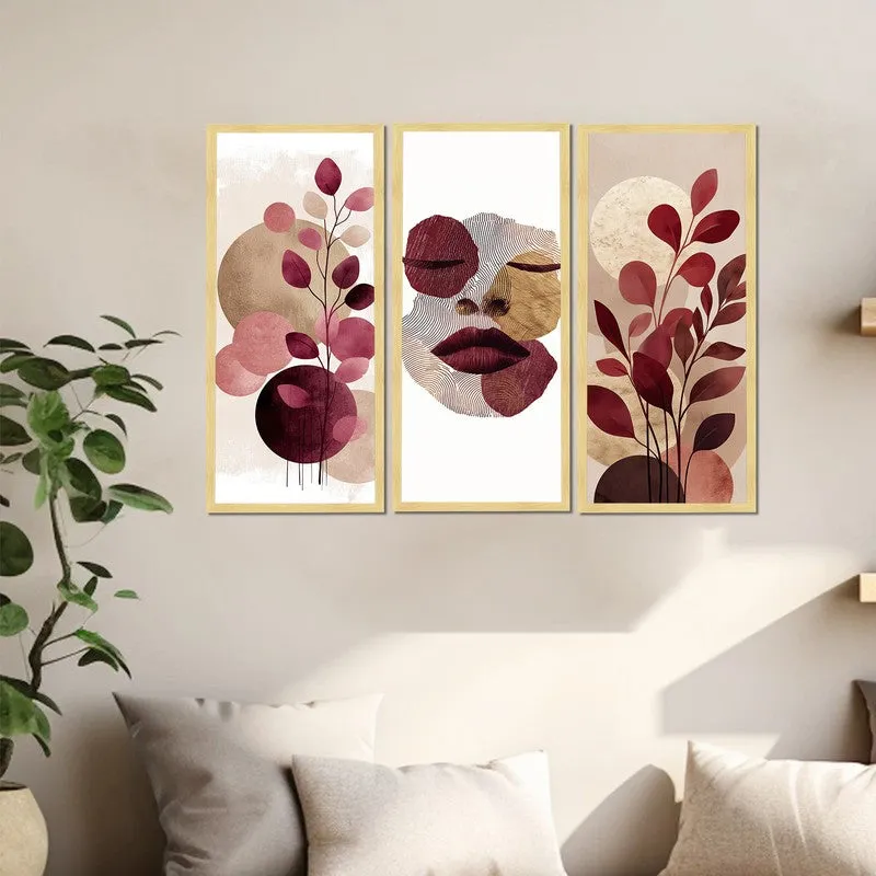 Set of three framed abstract prints with botanical forms and a face motif on a wall