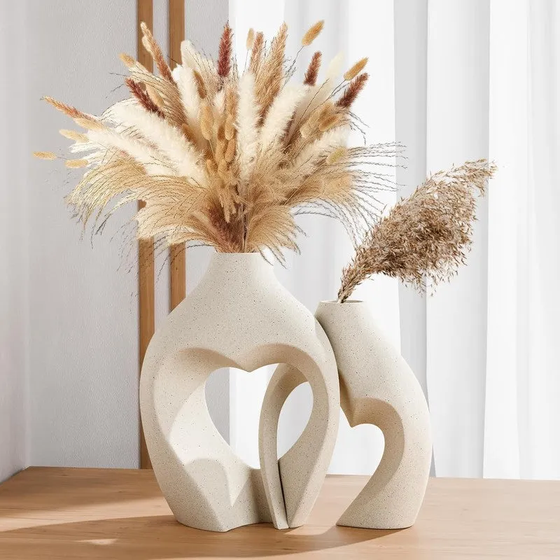 Set of two white abstract loop vases with dried grass stems