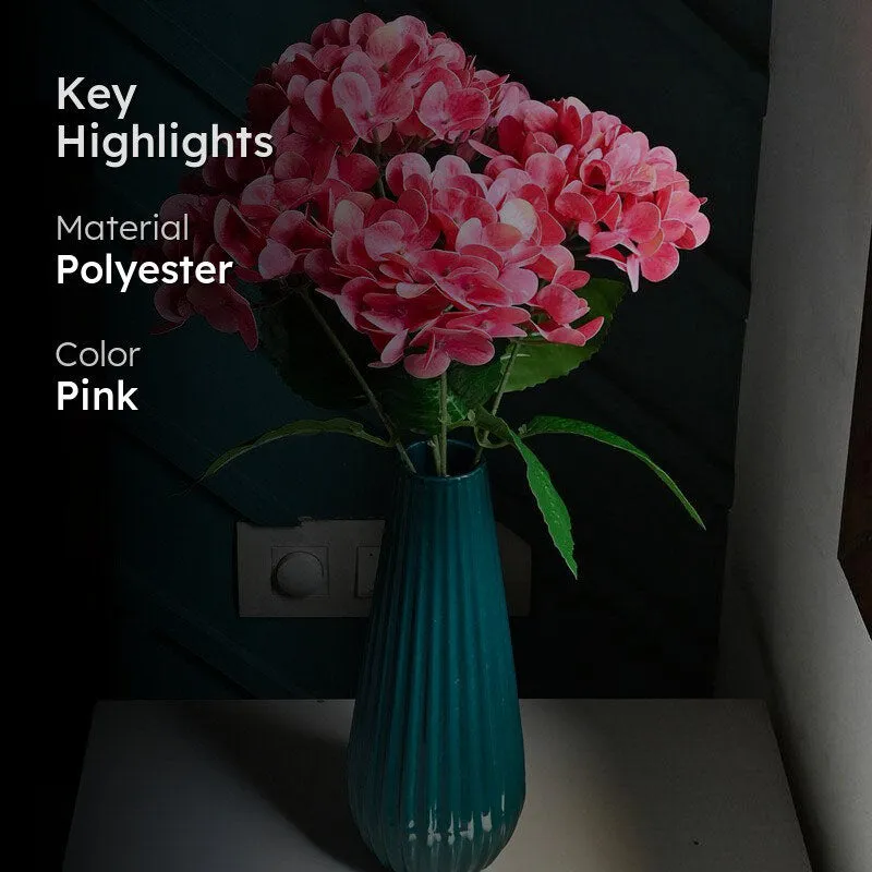 Pink artificial flower arrangement in a turquoise vase with material and colour text.