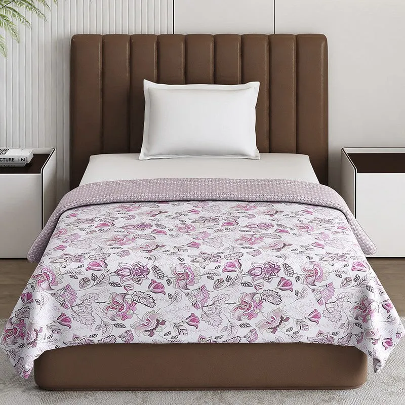 Front view of a pink floral dohar spread across a bed