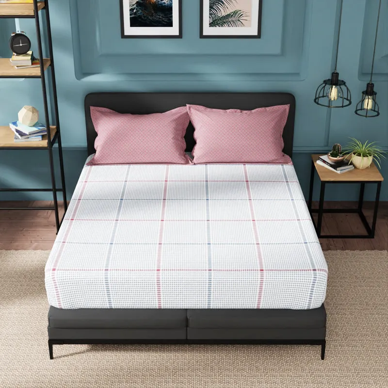 Front view of a blue and red checked fitted bedsheet on a double bed