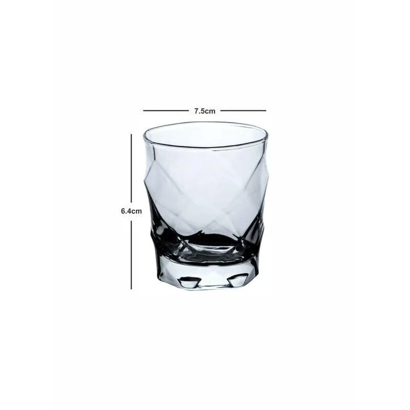 Single transparent faceted glass tumbler on a white background