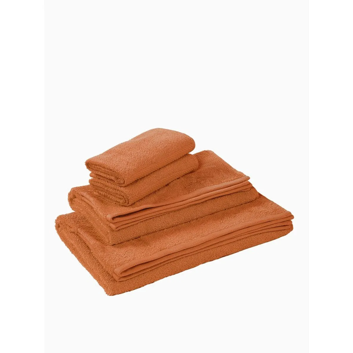 Folded orange towel set stacked on a white background