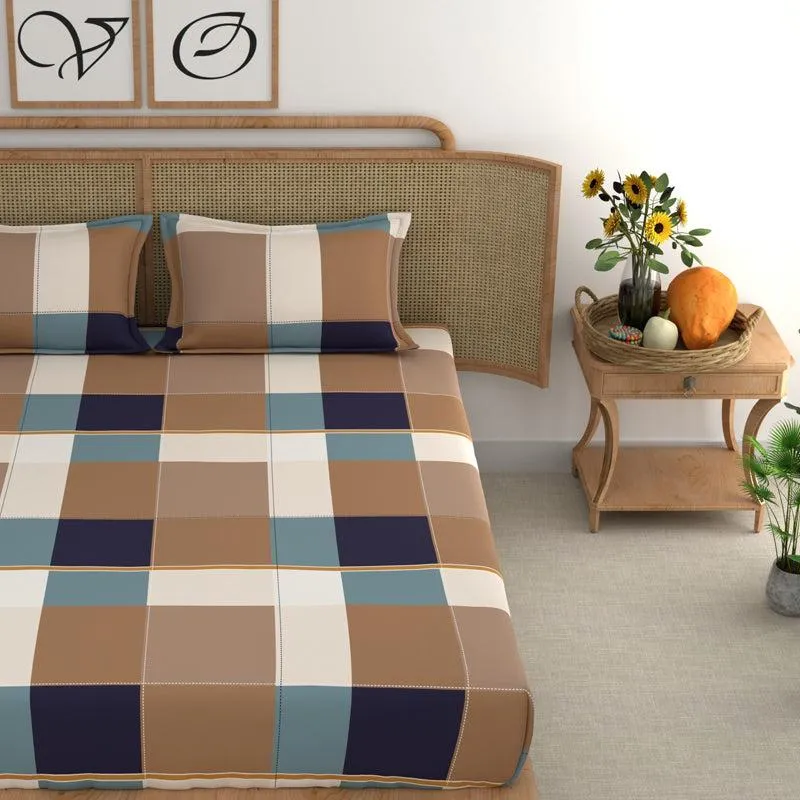 Close view of brown, cream and blue check bedsheet with matching pillow covers