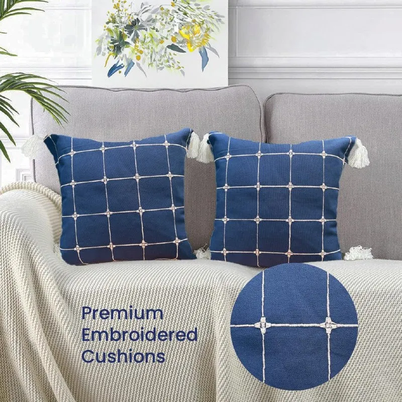 Pair of blue grid cushion covers on a light sofa with a close-up fabric inset