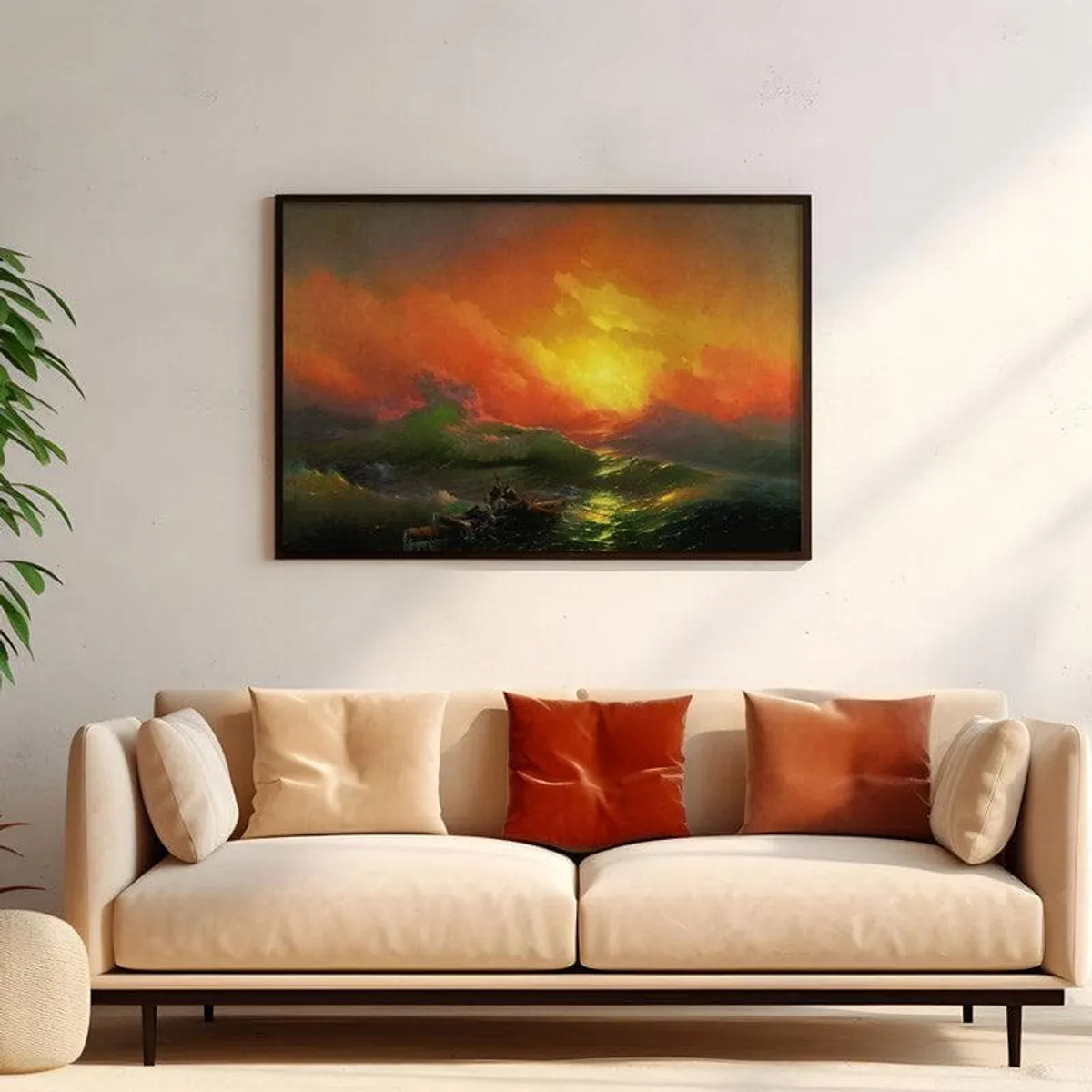 Framed ocean sunset painting displayed above a cream sofa with rust-toned cushions.