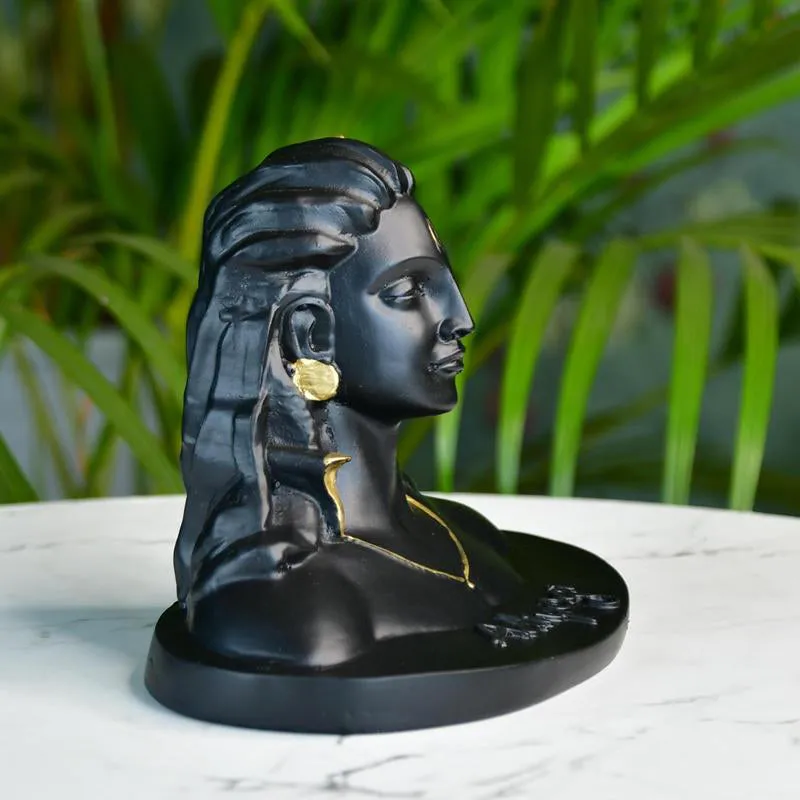 Side profile of the black Adiyogi showpiece with gold-toned detailing