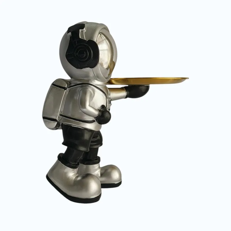 Side-back view of the astronaut figurine and its gold tray