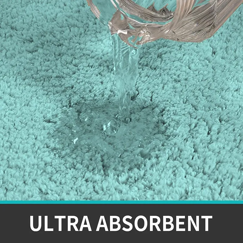 Water being poured onto the sea blue textured bath mat surface