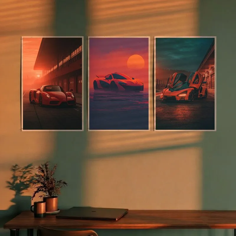 Set of three car wall posters displayed above a wooden desk