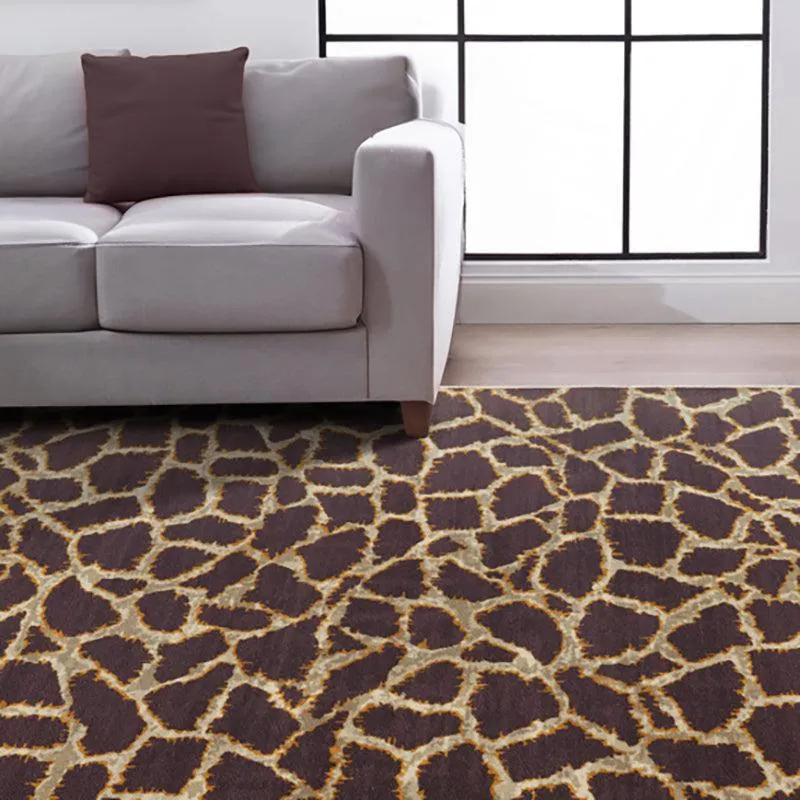Brown and beige abstract carpet placed under a light-coloured sofa