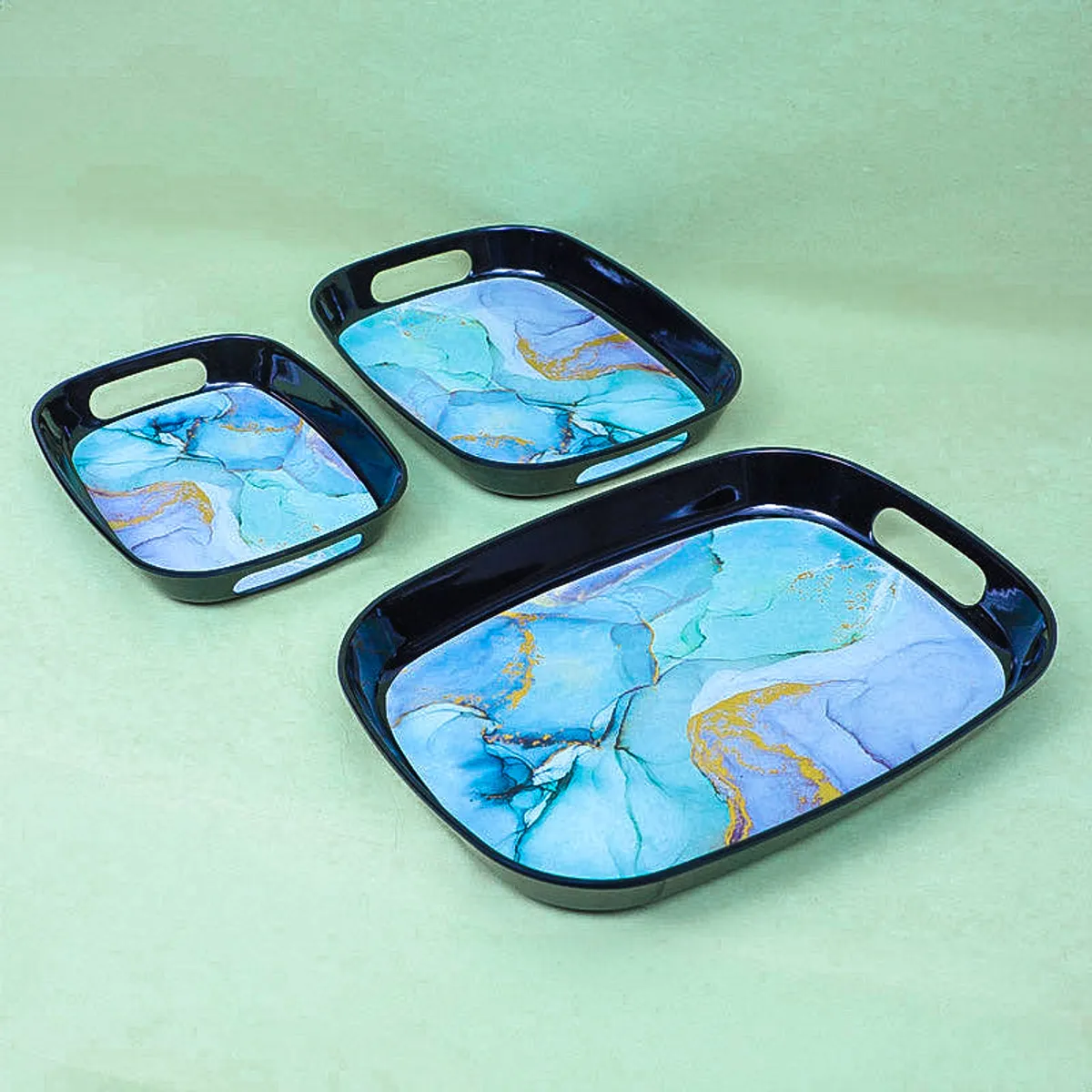 Large, medium and small blue marbled trays displayed separately