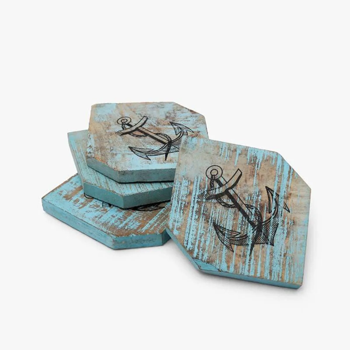 Three blue wooden coasters with anchor motifs arranged in a stack