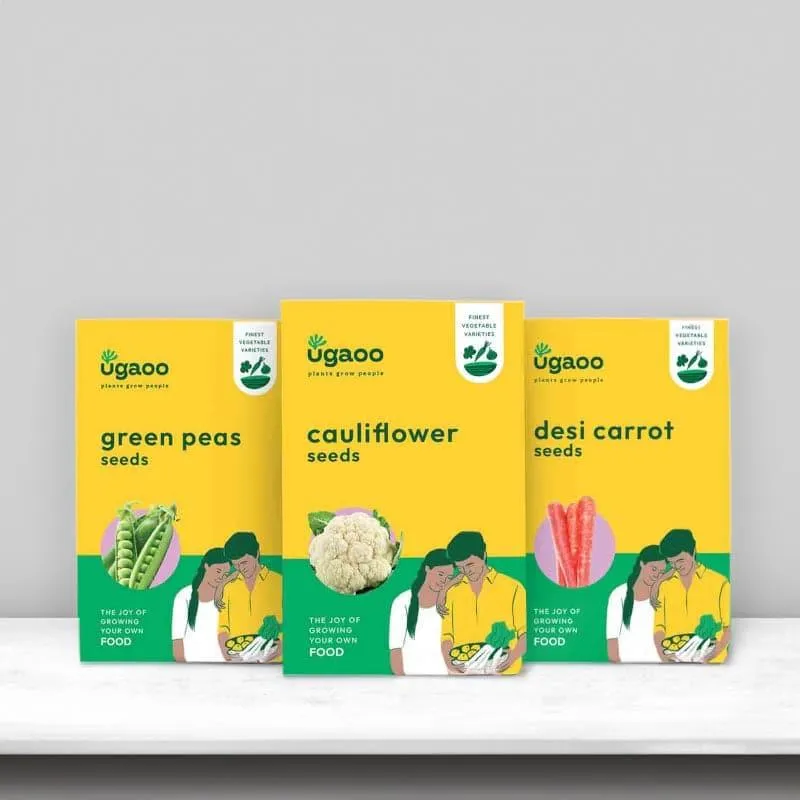 Three Ugaoo vegetable seed packs for green peas, cauliflower and desi carrot in yellow packaging