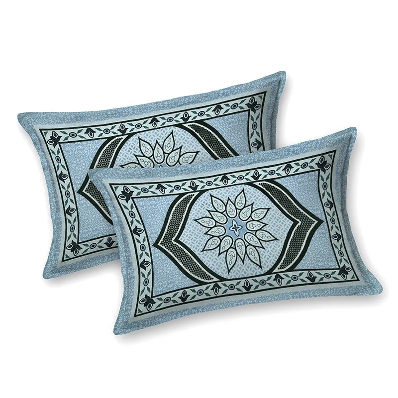 Two matching sky blue pillow covers with black floral-style motifs