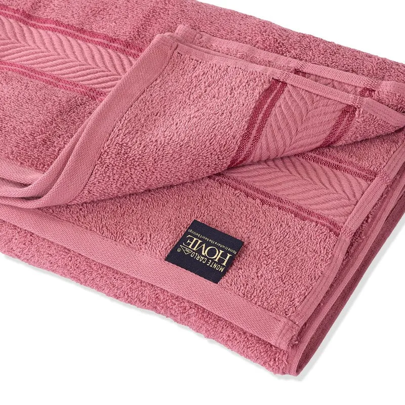 Close-up of folded pink bath towel with woven border