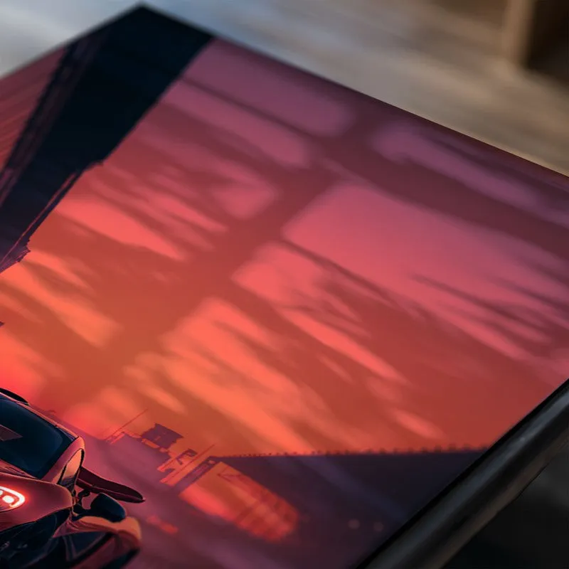 Close-up of a car poster in pink and orange sunset tones