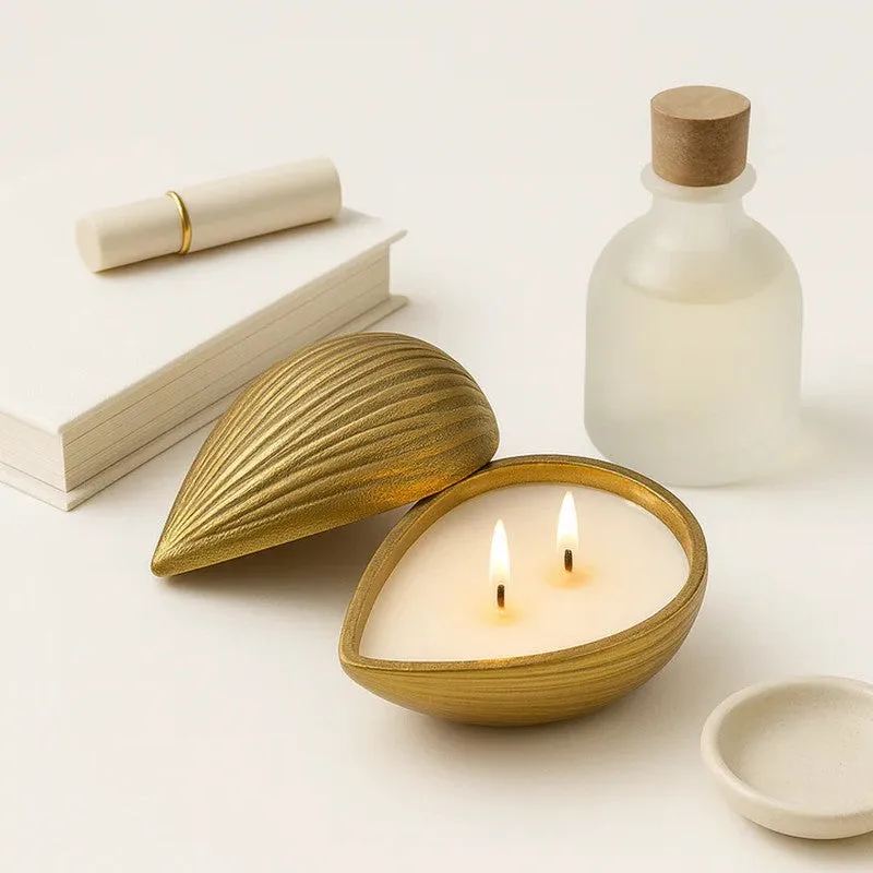 Golden almond-shaped candle styled with books and neutral décor