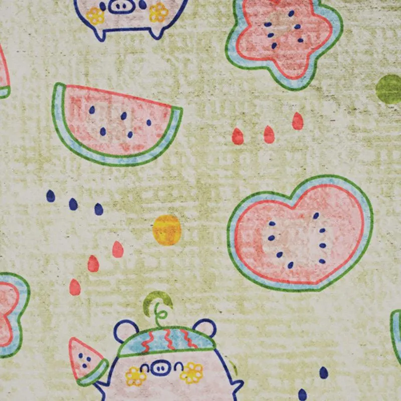 Close-up of the carpet with watermelon slices, flowers and cartoon pig motifs
