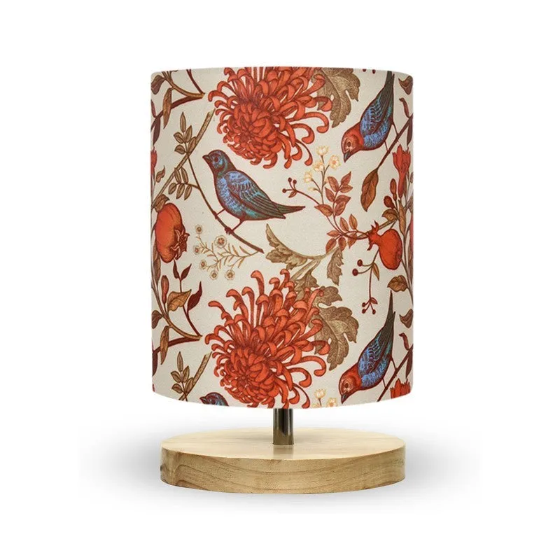 Front view of a multicolour bird and floral fabric-shade lamp with wooden base